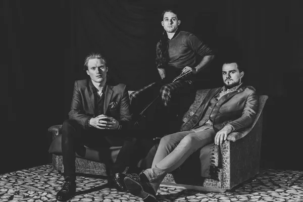 Exit Empire in 2019: Rafael Eimut, Timmy Ruzicka and Premek Ruzicka on a sofa, black and white